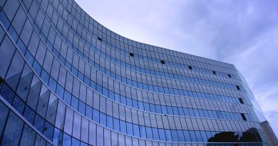 fish eye view photo of glass high story building over white cloudy sky during daytime