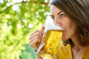 photo of woman drinking beer