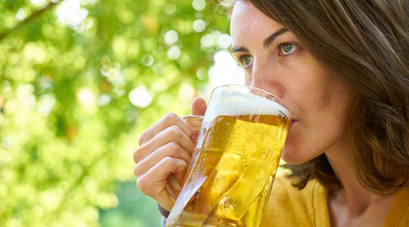 photo of woman drinking beer