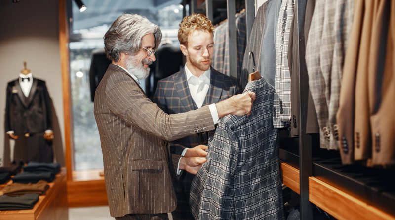 men picking a suit in a suit shop